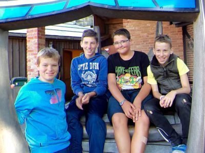 a group of boys sitting on steps