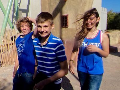 a group of kids in blue shirts