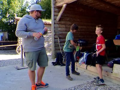 a man standing outside with two boys