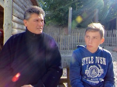 a man and boy sitting outside