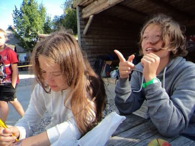 a couple of girls sitting at a table