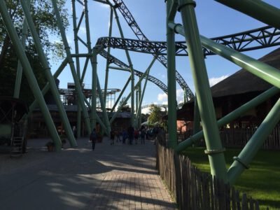 a roller coaster with people walking around